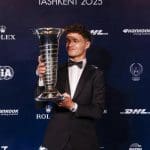 Lando Norris şampiyonluk kupasıyla poz verirken, 125 karakter