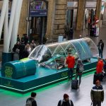 Aston Martin F1 Glenfiddich Car in a Bottle kus bakisi Kings Cross tam kurulum yesil platform kalabalik Londra 2026