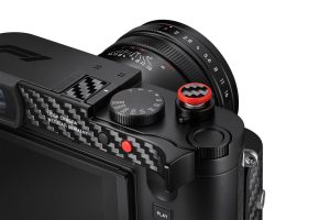 Leica Q3 43 F1 Edition üst panel — karbon fiber aksesuar tepsisi, kırmızı deklanşör butonu ve APO-Summicron 43mm lens, Wetzlar Germany yazısı